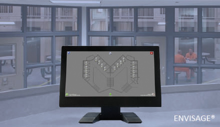 All-in-one computer showing ENVISAGE® overlaid on a photo of the interior of a prison